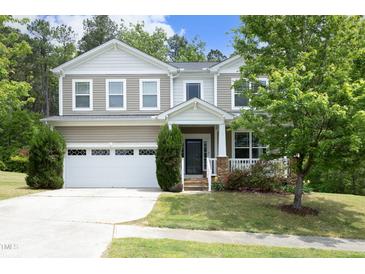 Charming two-story home featuring a two-car garage, front porch, and beautifully landscaped front yard at 1106 Red Crest Ln, Durham, NC 27704