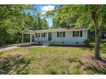 Charming single-story home featuring a covered front porch and well-maintained landscaping at 2108 Laurel Mill Centerville Rd, Louisburg, NC 27549