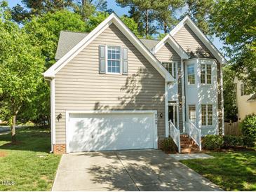 Charming two-story home with a two-car garage, manicured lawn, and beautiful architectural details at 2309 Clerestory Pl, Raleigh, NC 27615