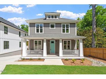 Charming two-story home with a welcoming front porch and professionally landscaped yard at 3932 Old Chapel Hill Rd, Durham, NC 27707