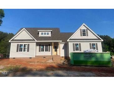 Charming single-Gathering home with gray siding, black shutters and a nicely framed front door at 499 Mulberry Rd, Spring Hope, NC 27882