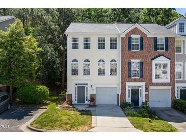 Charming townhome with well-manicured lawn, single car garage, and beautiful architectural details at 5420 Vista View Ct, Raleigh, NC 27612
