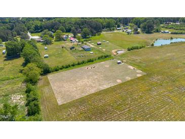 Expansive aerial view showcases acreage, pond, and serene homesites in a rural community at 5423 Nc-39, Selma, NC 27576