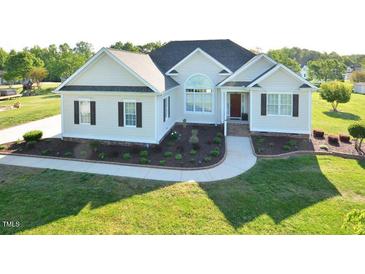 Beautiful home showcasing a manicured front yard, walkway, and inviting entrance at 55 Derwin Dr, Timberlake, NC 27583