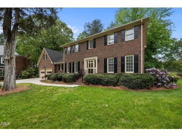 Beautiful brick two-story home with well-maintained lawn, manicured shrubs, and mature trees at 804 Warwick Ct, Burlington, NC 27215