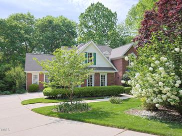Charming brick home with a circular driveway and beautifully landscaped front yard at 110 Blackford Ct, Durham, NC 27712