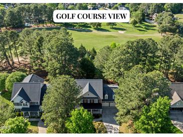 Stunning home with golf course views surrounded by lush greenery and mature trees at 1401 Marshall Farm St, Wake Forest, NC 27587