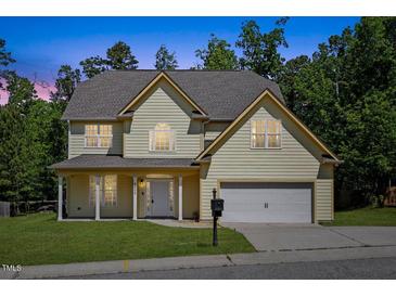 Charming two-story home featuring a two-car garage, landscaped lawn, and a welcoming front porch at 1605 Sassafras St, Durham, NC 27712