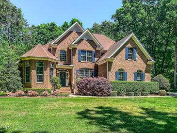 Beautiful brick home with manicured lawn and blue shutters at 19 Rivers Edge Ct, Timberlake, NC 27583