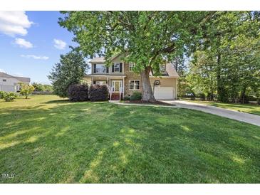 Charming home with a large front yard, mature tree, and a two car garage at 210 Mediate Dr, Raleigh, NC 27603