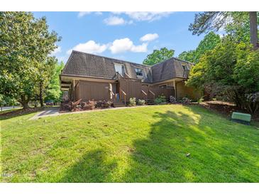 Attractive two-story townhome with a well-manicured lawn and charming exterior details at 213 Summerwalk Cir, Chapel Hill, NC 27517