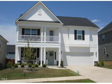 Charming two-story home with a covered porch and well-maintained lawn at 222 Oak Branch Trl, Garner, NC 27529