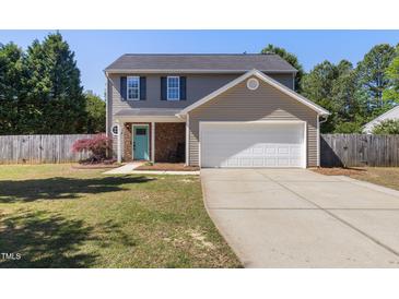 Charming two-story home features a teal front door and well-maintained lawn at 401 Onondaga Ct, Holly Springs, NC 27540
