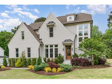 Charming painted-brick home featuring professionally landscaped lawn and a welcoming front entrance at 46 Bonterra Way, Chapel Hill, NC 27516