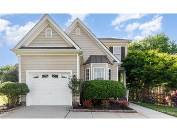 Charming home with a two-car garage, beautiful bay window, and well-manicured landscaping at 5504 Creekdale Cir, Raleigh, NC 27612