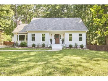 Charming single-story home with a well-manicured lawn and inviting front entrance at 5642 Falkirk Dr, Durham, NC 27712