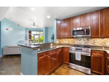 Modern kitchen features stainless steel appliances, granite counters, and stylish backsplash at 618 N Boylan Ave # 622, Raleigh, NC 27603