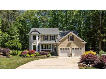 Charming two-story home featuring a two-car garage and lush landscaping at 624 Moultonboro Ave, Wake Forest, NC 27587