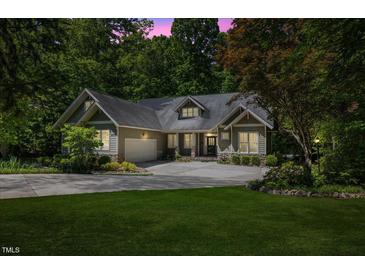 Charming single-story home with manicured lawn, lush landscaping, and a spacious driveway at 6509 Mountain Brook Ln, Raleigh, NC 27615