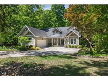 Charming home with a well-manicured lawn, attached garage, and beautiful landscaping at 6509 Mountain Brook Ln, Raleigh, NC 27615
