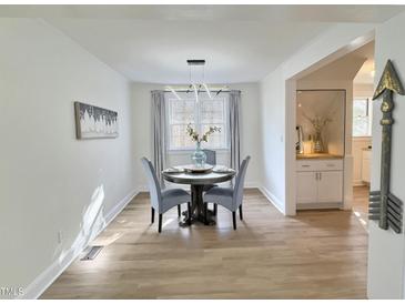 Charming dining room featuring a round table with seating for four and modern light fixture at 707 Wade Ave, Raleigh, NC 27605