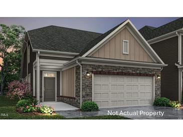Charming exterior features a stone facade, two-car garage, and landscaped front yard at 708 Blackpool Dr, Durham, NC 27703