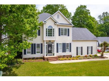 Beautiful two-story home with black shutters, tidy landscaping, and a welcoming front porch at 8600 Clivedon Dr, Raleigh, NC 27615