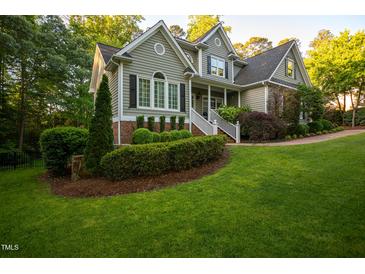 Charming two-story home with manicured lawn and lush landscaping at 945 Jones Wynd, Wake Forest, NC 27587