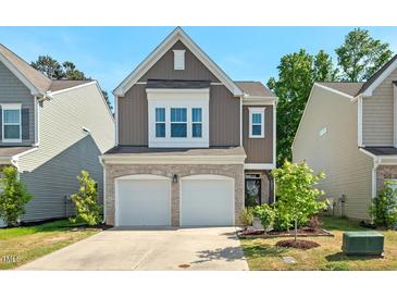 Charming two-story home featuring a two-car garage and beautifully landscaped front yard at 1021 Sweet Cream Ct, Durham, NC 27703