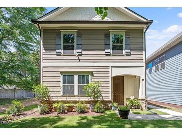 Charming home featuring neutral siding, complementary shutters, and a well-manicured front lawn at 1041 Cotulla Dr, Morrisville, NC 27560
