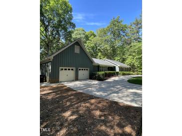 Charming home with a two-car garage and well-maintained landscaping at 10505 Winding Wood Trail Trl, Raleigh, NC 27613