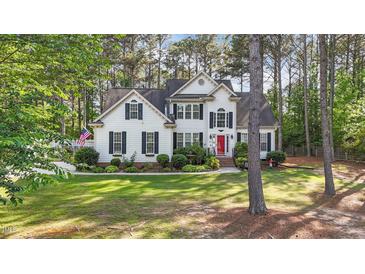 Charming two-story home with manicured lawn and a welcoming red front door at 106 Wolverton Dr, Clayton, NC 27527