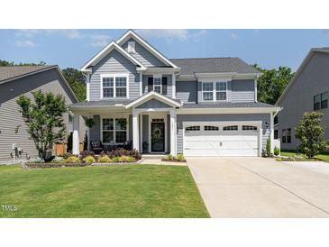Charming two-story home with a well-manicured lawn, beautiful landscaping and a two car garage at 121 Woodstaff Ave, Wake Forest, NC 27587