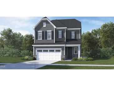 Two-story home with gray siding, a two-car garage, and a well-manicured lawn at 136 Fairport Ln, Apex, NC 27539