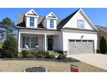 Charming two-story home featuring a welcoming front porch and a two-car garage at 145 Plantation Dr, Youngsville, NC 27596