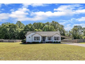 Charming home features a well-maintained lawn, tasteful landscaping, and a convenient covered parking area at 2006 Woodstone Dr, Archer Lodge, NC 27527
