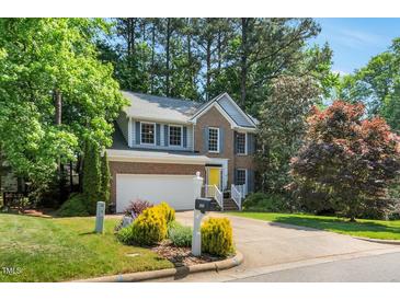 Charming brick home with a yellow front door and well-maintained landscaping at 2018 Waterton Ln, Apex, NC 27502