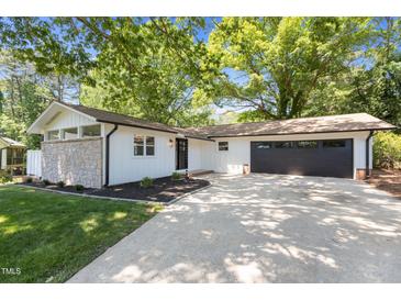 Charming renovated home with stone accents, attached garage and a well-manicured front yard with mature trees at 2505 Catalina Ct, Raleigh, NC 27607