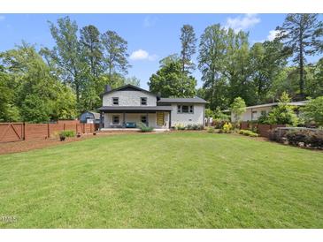 Charming two-story home with a beautifully landscaped front yard and a welcoming front porch at 3704 Swann St, Raleigh, NC 27612