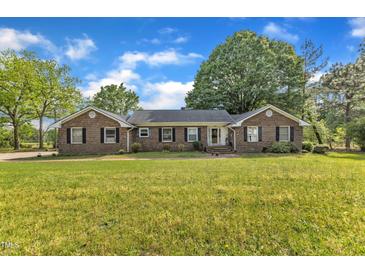 Charming brick home featuring a spacious front yard and manicured landscaping at 4314 Hopkins Rd, Middlesex, NC 27557