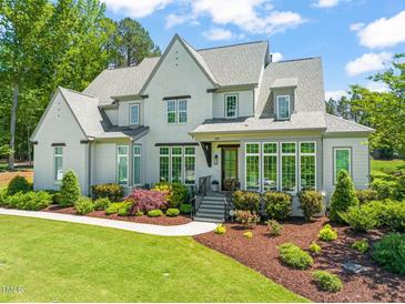 Beautiful two-story home featuring manicured landscaping and a welcoming front entrance at 6208 Old Miravalle Ct, Raleigh, NC 27614