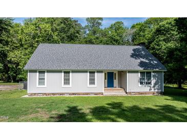 Charming single-story home with a well-maintained lawn and a welcoming blue front door at 726 Thomas Rd, Rocky Mount, NC 27801