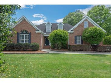 Charming brick home with a well-manicured lawn and mature landscaping at 1 Plowlan Ct, Durham, NC 27707