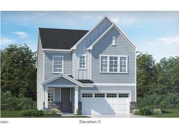 Charming two-story home with stone accents, gray siding, and a bright white garage at 104 Corapeake Way, Apex, NC 27539