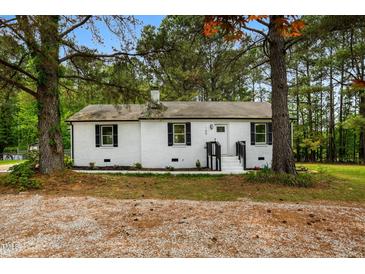 Charming brick home with black shutters, a black front door, and landscaped front yard at 109 Riverbend Dr, Archer Lodge, NC 27527