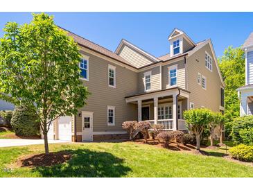 Charming two-story home with a well-manicured lawn, a covered front porch, and attached garage at 113 Ruskin Dr, Chapel Hill, NC 27516