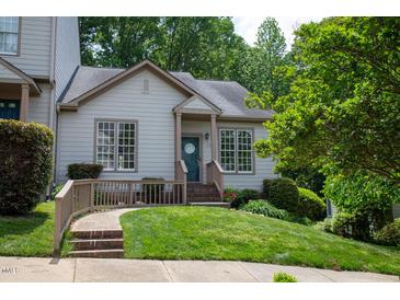Charming home featuring a well-maintained lawn, attractive landscaping, and welcoming front porch at 205 Windbyrne Dr, Cary, NC 27513