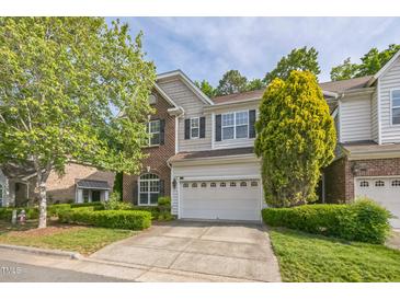 Charming two-story home with a two car garage and well-manicured front lawn and brick facade at 216 Beringer Pl, Chapel Hill, NC 27516