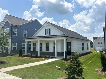 Charming single-story home with a welcoming front porch and beautifully landscaped yard at 2874 Quarry Rd # 165, Rolesville, NC 27571