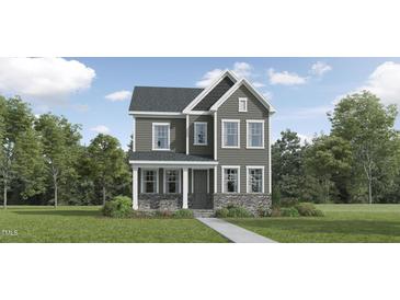 Charming two-story home with gray siding, stone accents, and a welcoming front porch at 312 Calvander Ln, Apex, NC 27539